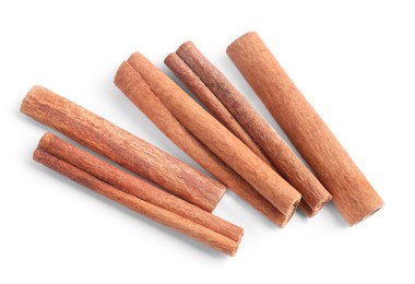 Photo of Aromatic cinnamon sticks isolated on white, top view