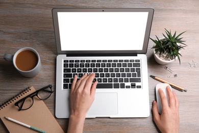 Young woman using modern computer at table in office, top view. Space for design