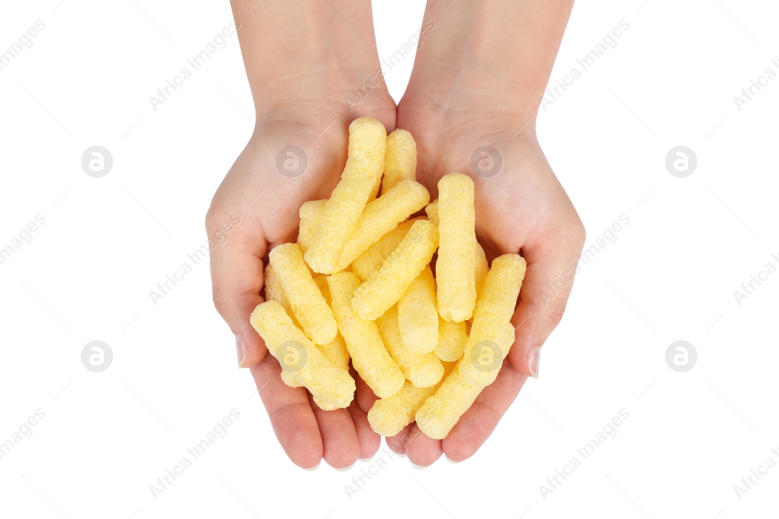 Photo of Woman holding pile of tasty corn puffs on white background, top view