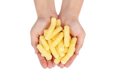 Woman holding pile of tasty corn puffs on white background, top view