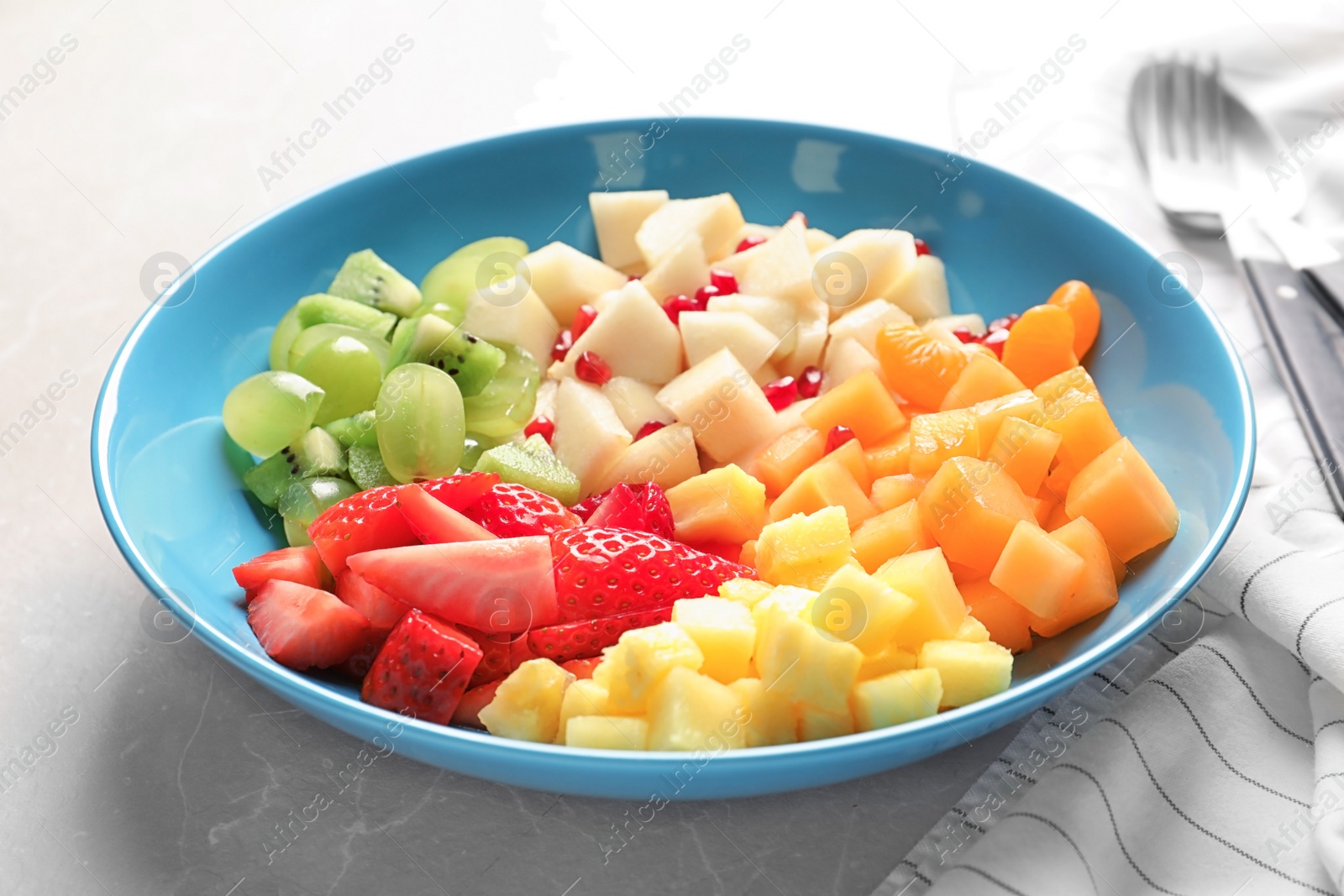 Photo of Plate with fresh cut fruits on table, closeup