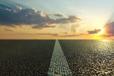 View of empty asphalt road at sunset