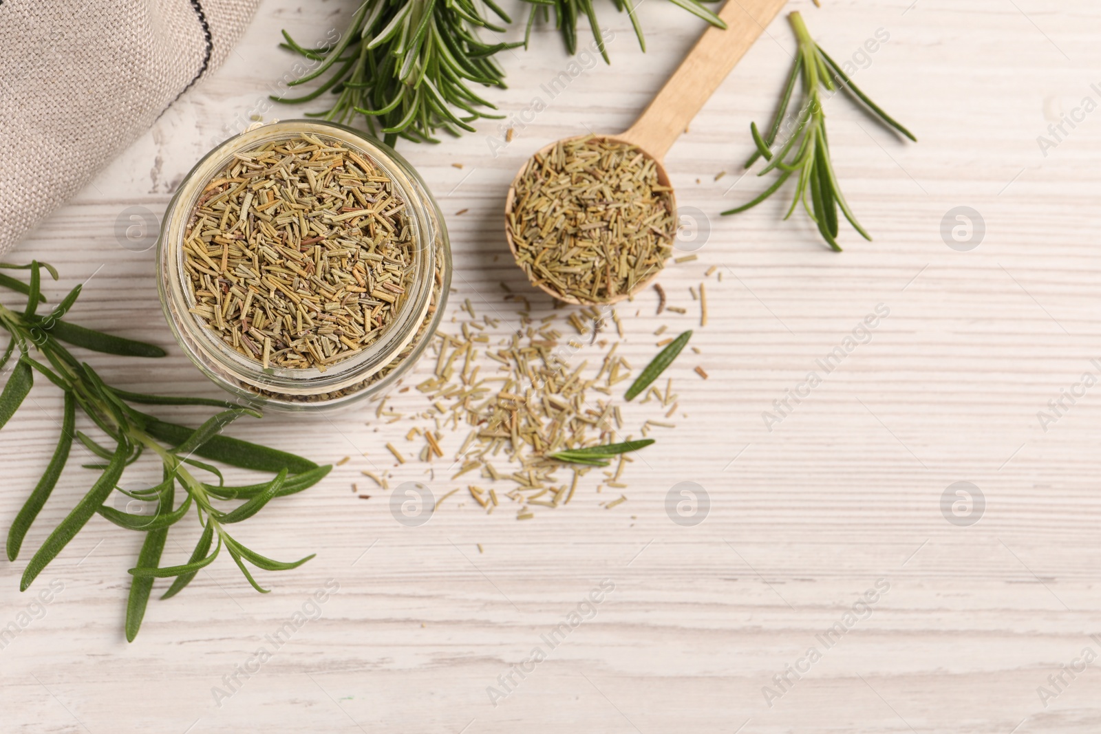 Photo of Fresh and dry rosemary on white wooden table, flat lay. Space for text