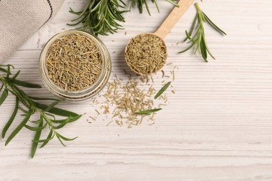 Fresh and dry rosemary on white wooden table, flat lay. Space for text