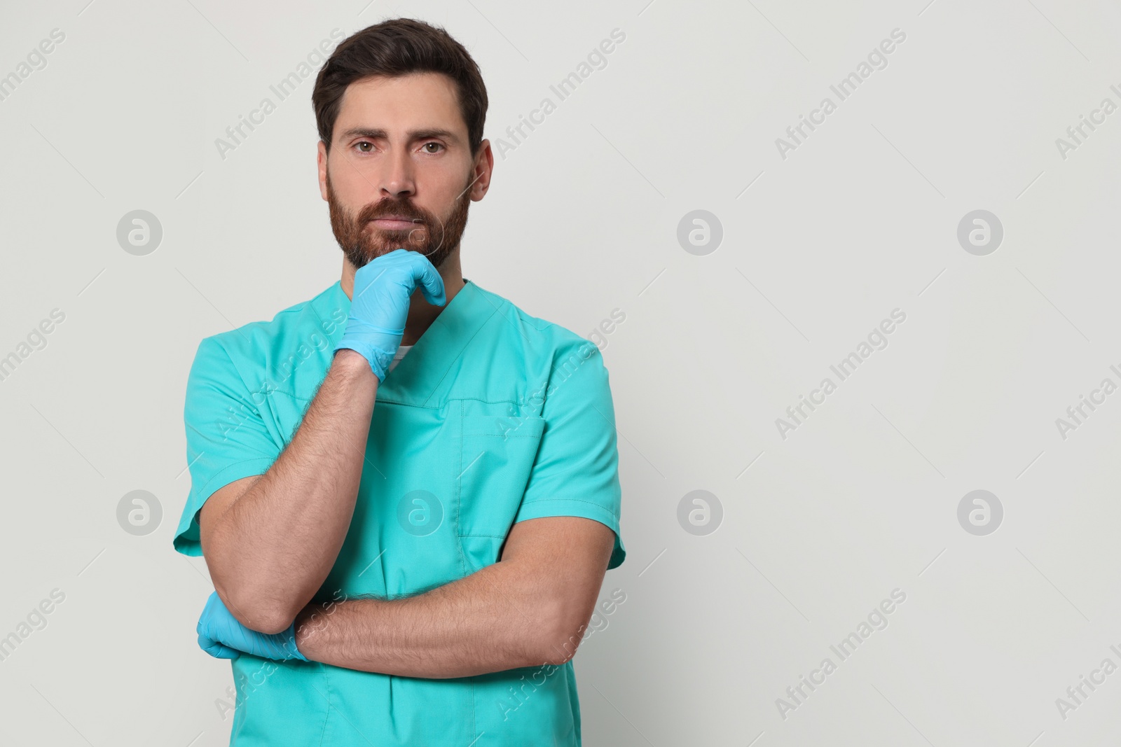 Photo of Nurse in medical uniform on white background, space for text