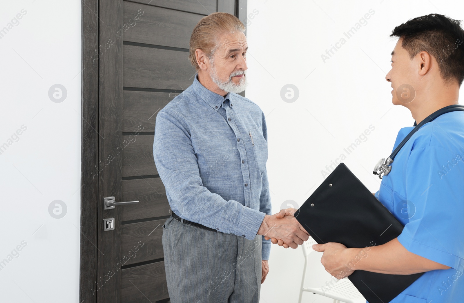 Photo of Doctor shaking hands with patient in hospital