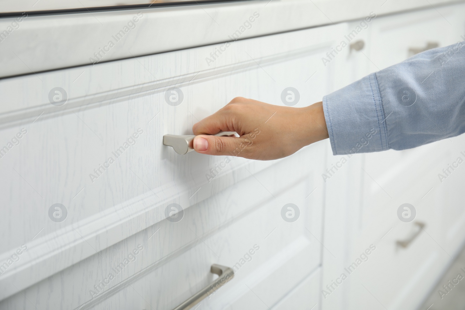 Photo of Woman opening drawer at home, closeup view