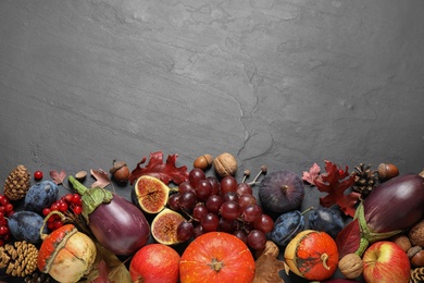 Photo of Flat lay composition with autumn vegetables and fruits on grey background, space for text. Happy Thanksgiving day