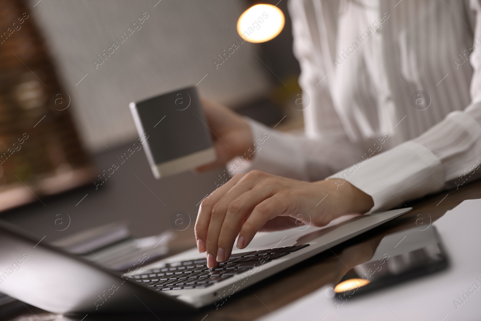 Photo of Woman working with laptop in office, closeup