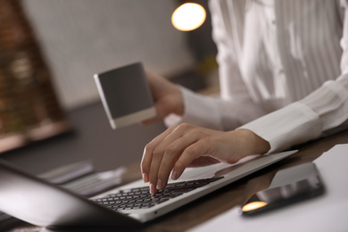 Woman working with laptop in office, closeup