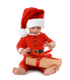 Photo of Festively dressed baby with gift box on white background. Christmas celebration