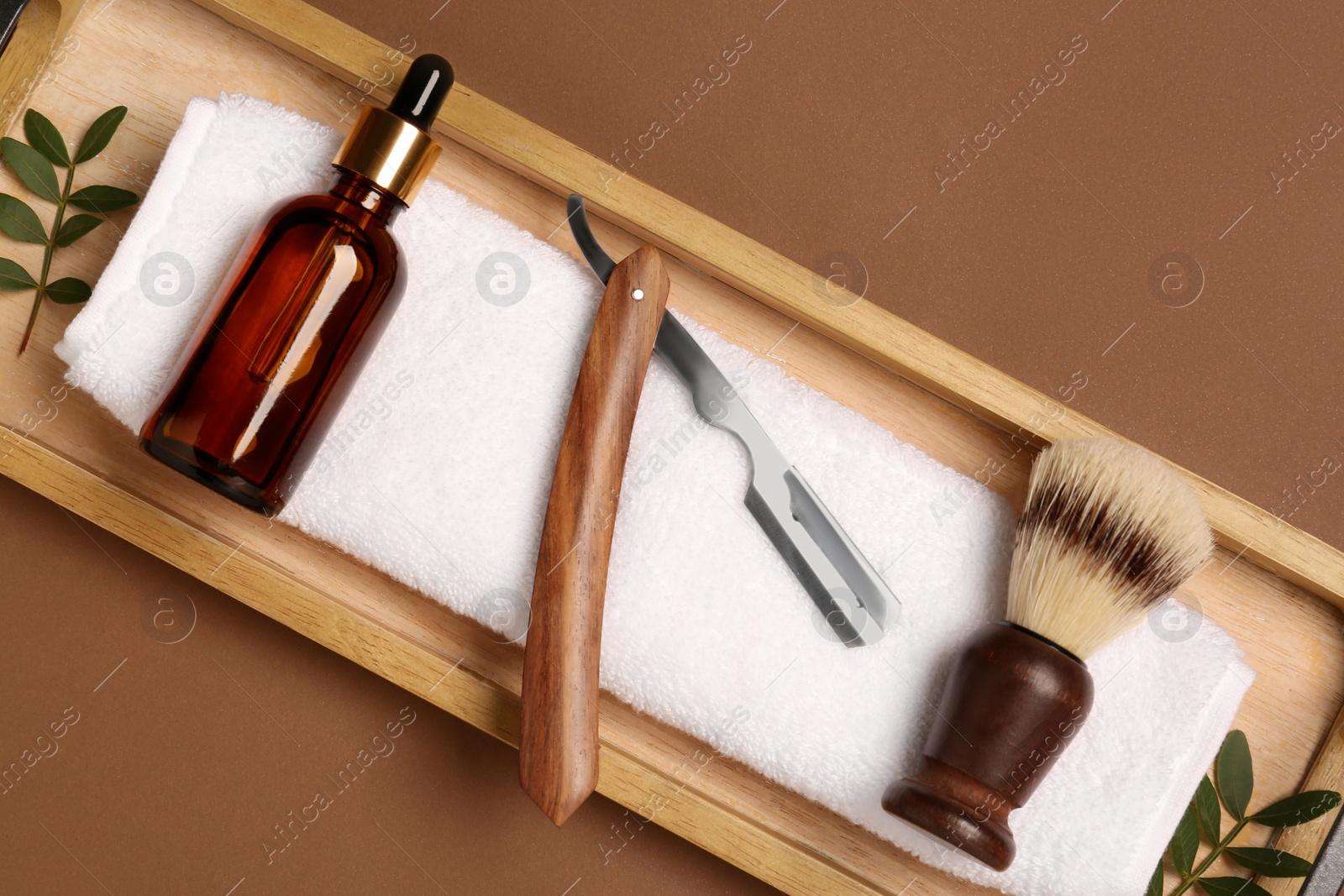 Photo of Set of men's shaving tools on brown background, top view