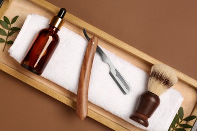 Photo of Set of men's shaving tools on brown background, top view