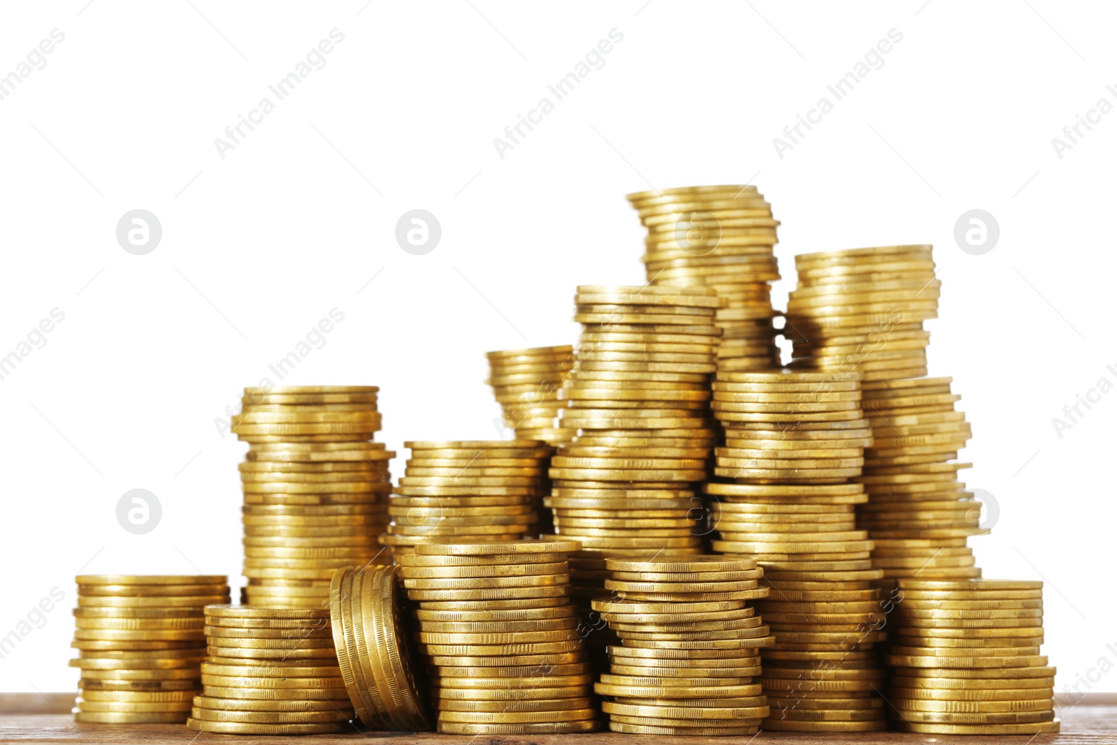 Photo of Stack of coins on wooden table, closeup