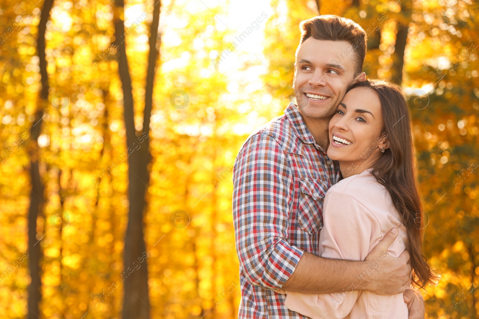 Photo of Happy couple in sunny park. Autumn walk