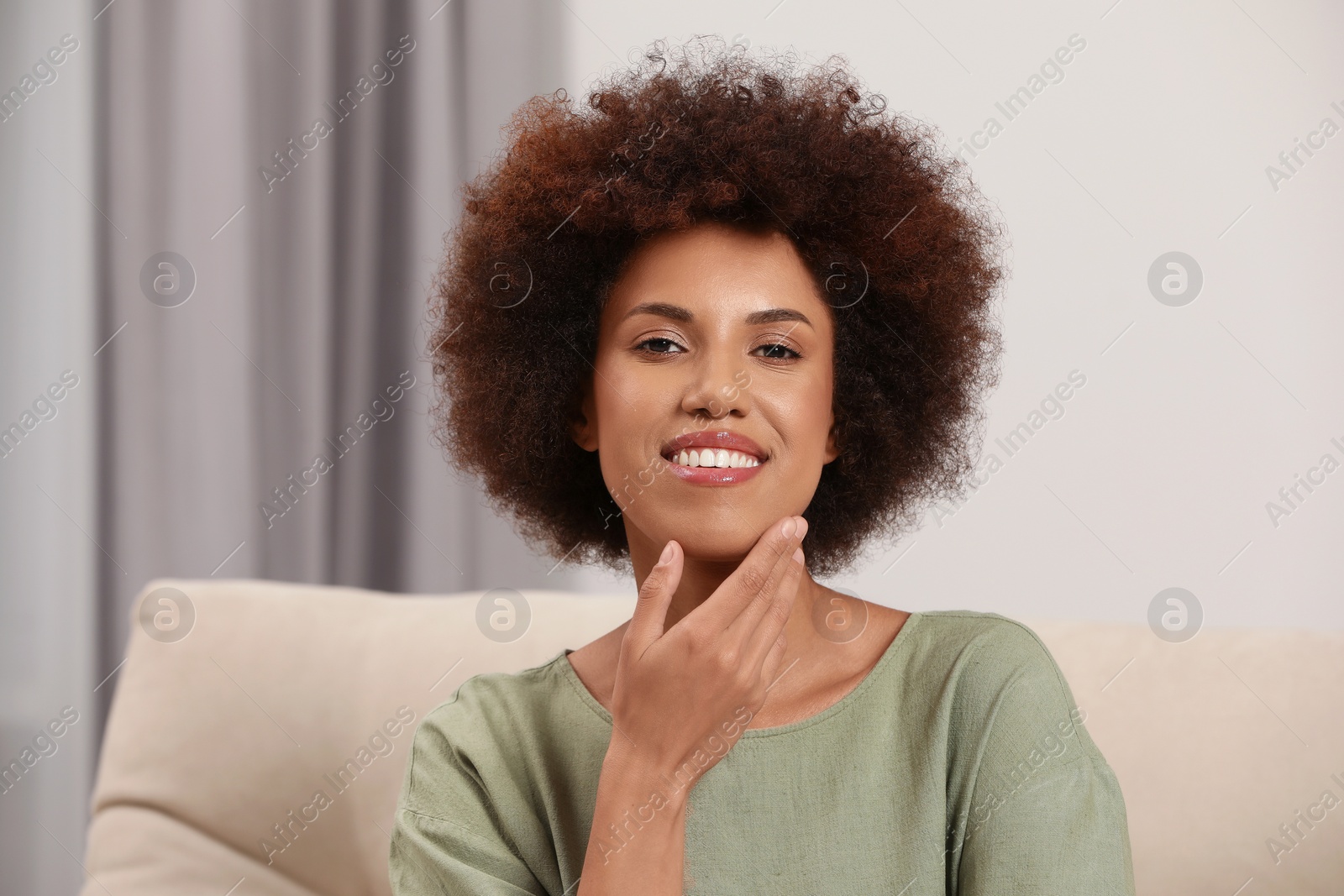 Photo of Portrait of beautiful young woman with glamorous makeup at home