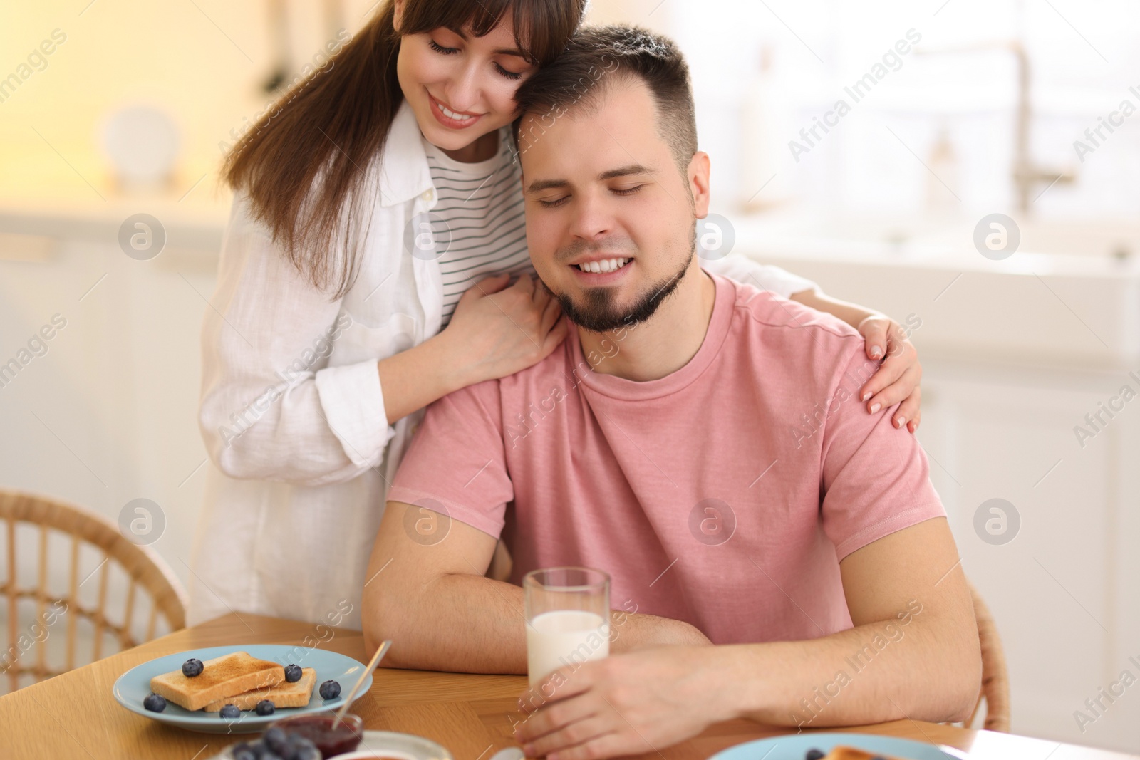 Photo of Lovely couple spending time together during breakfast at home