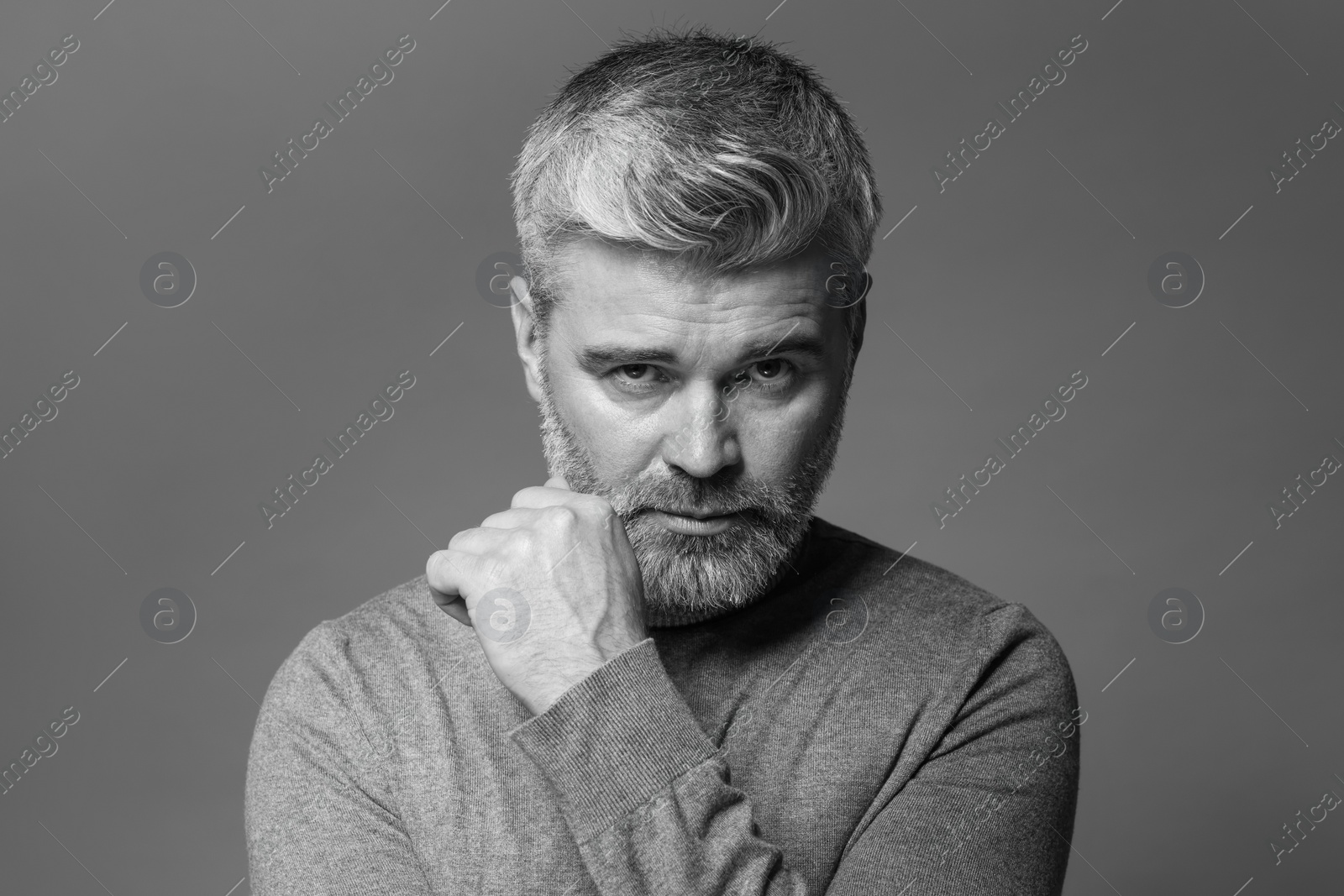 Photo of Portrait of handsome man on grey background. Black and white effect