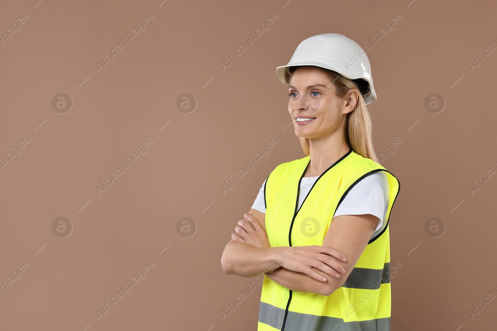 Photo of Engineer in hard hat on brown background