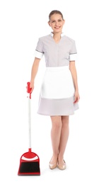 Young chambermaid with broom and dustpan on white background