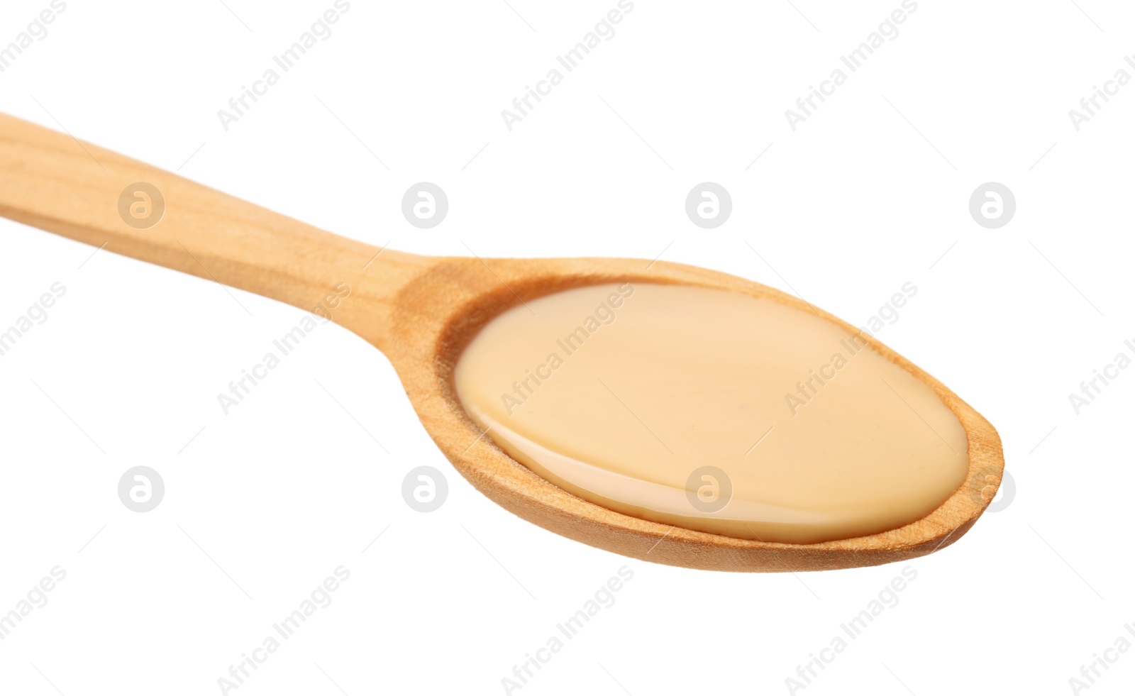 Photo of Wooden spoon with tasty peanut butter isolated on white