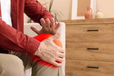 Image of Man suffering from rheumatism in knee at home, closeup. Space for text