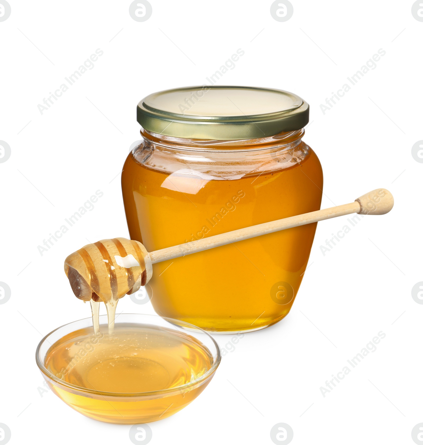 Image of Natural honey dripping from dipper into glass bowl. Jar full of honey on white background