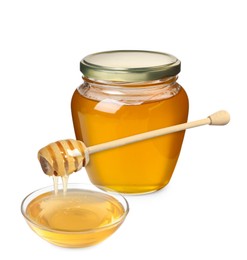 Natural honey dripping from dipper into glass bowl. Jar full of honey on white background