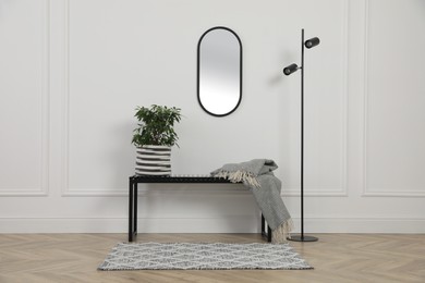 Photo of Modern hallway with bench and floor lamp. Interior design