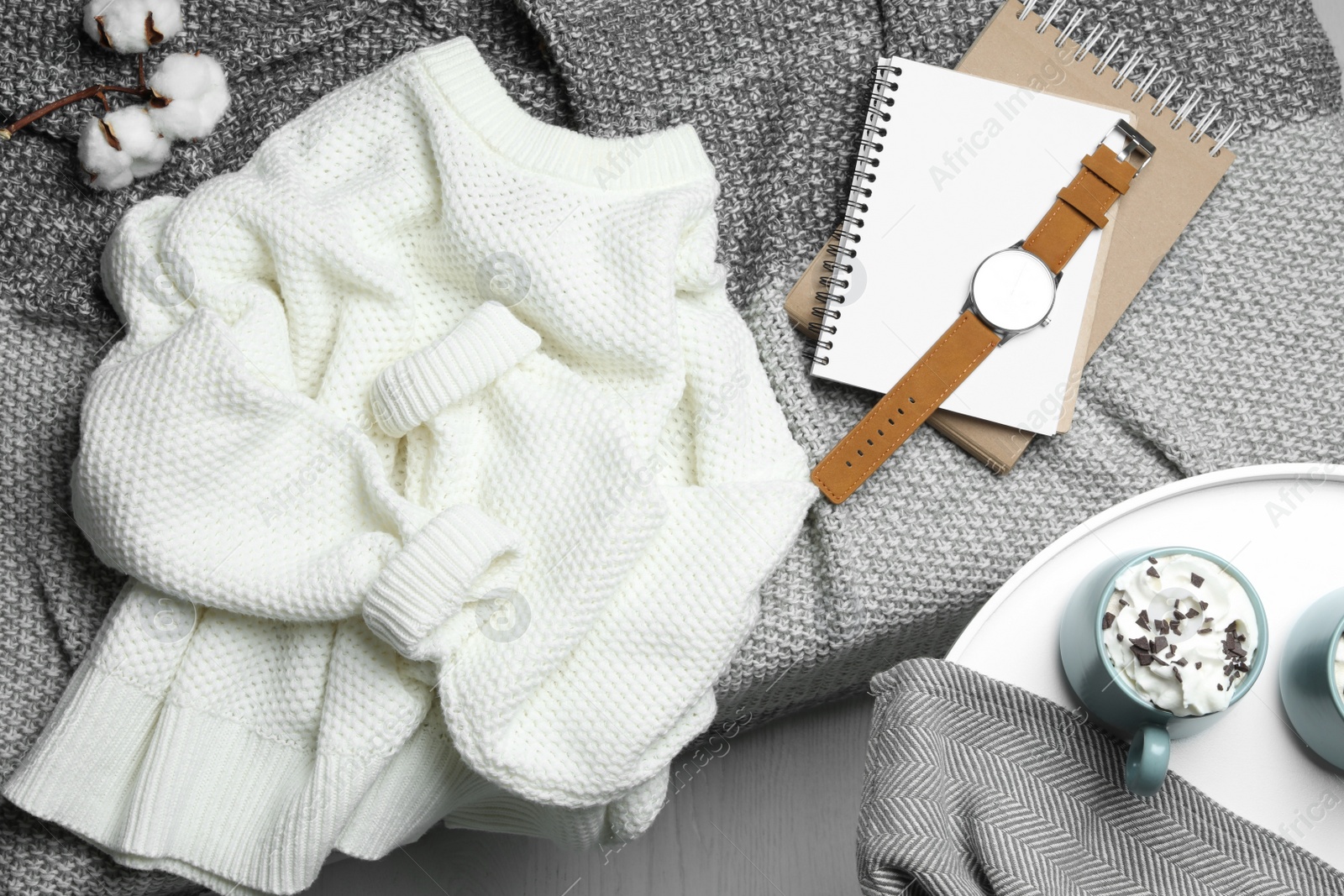 Photo of Knitted sweater on bed at home, flat lay