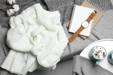 Knitted sweater on bed at home, flat lay