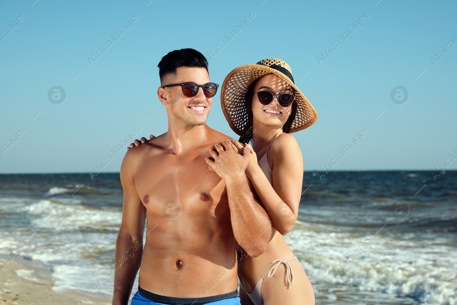 Photo of Lovely couple spending time together on beach