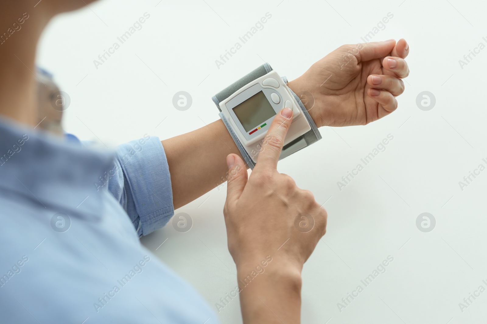 Photo of Woman checking blood pressure with sphygmomanometer at table, closeup. Cardiology concept