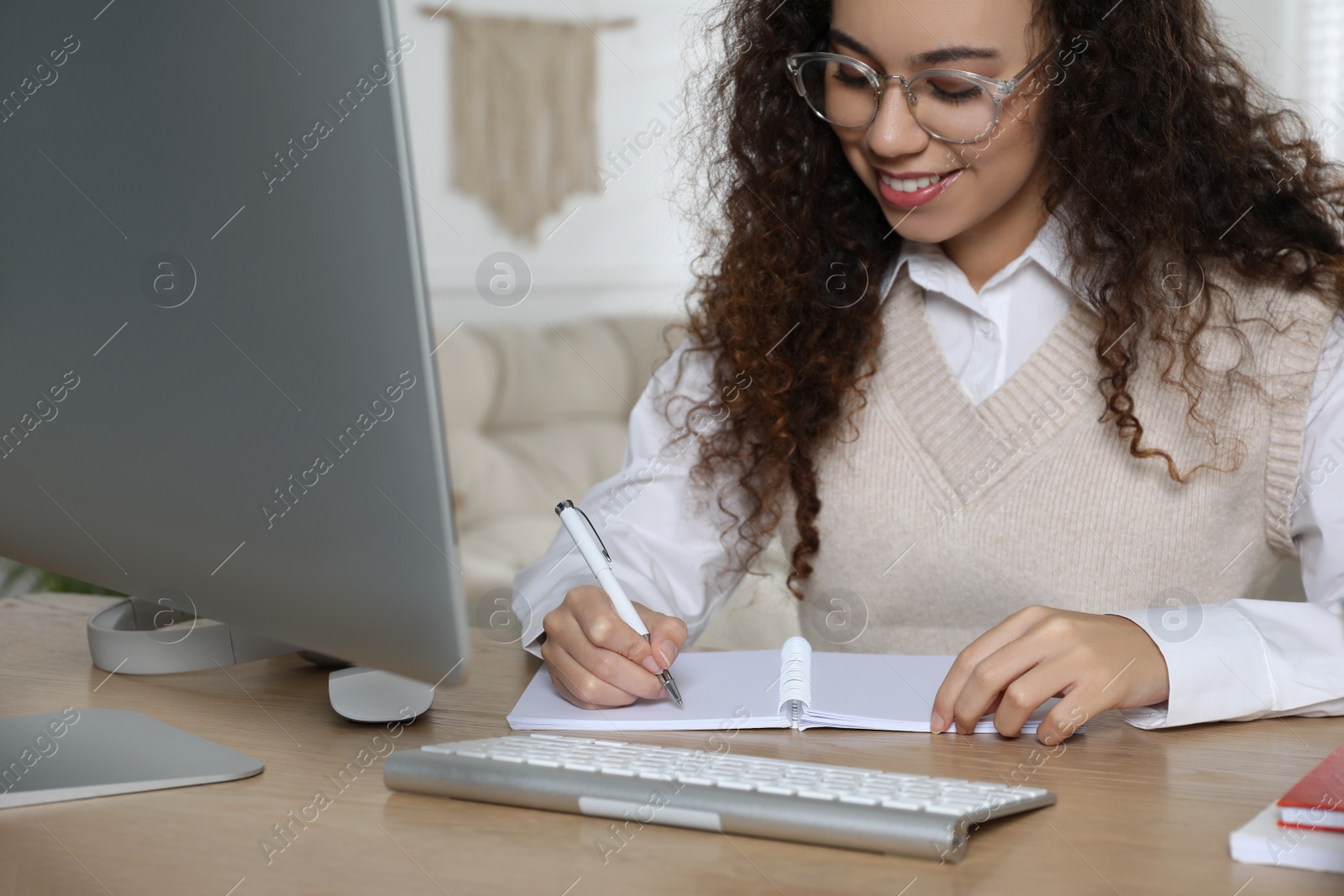 Photo of African American woman studying at home. Distance learning