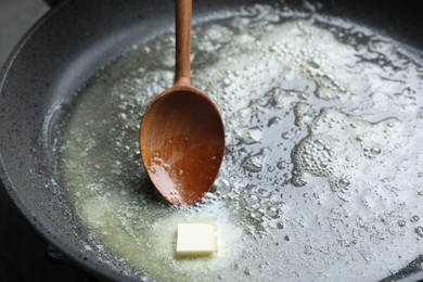 Photo of Melting butter in frying pan, closeup view