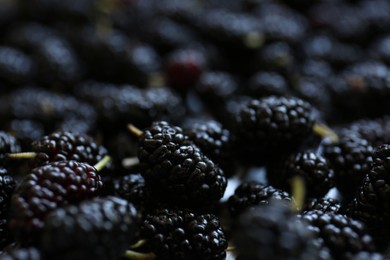 Photo of Heap of delicious ripe black mulberries, closeup view