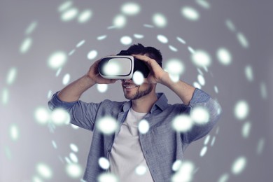 Innovation idea. Man using VR headset. Lights around him symbolizing digital reality