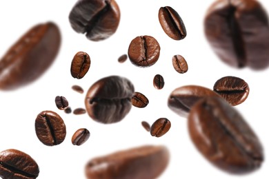 Roasted coffee beans falling o white background