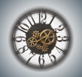 Clock with cogwheels, motion blur effect. Time concept