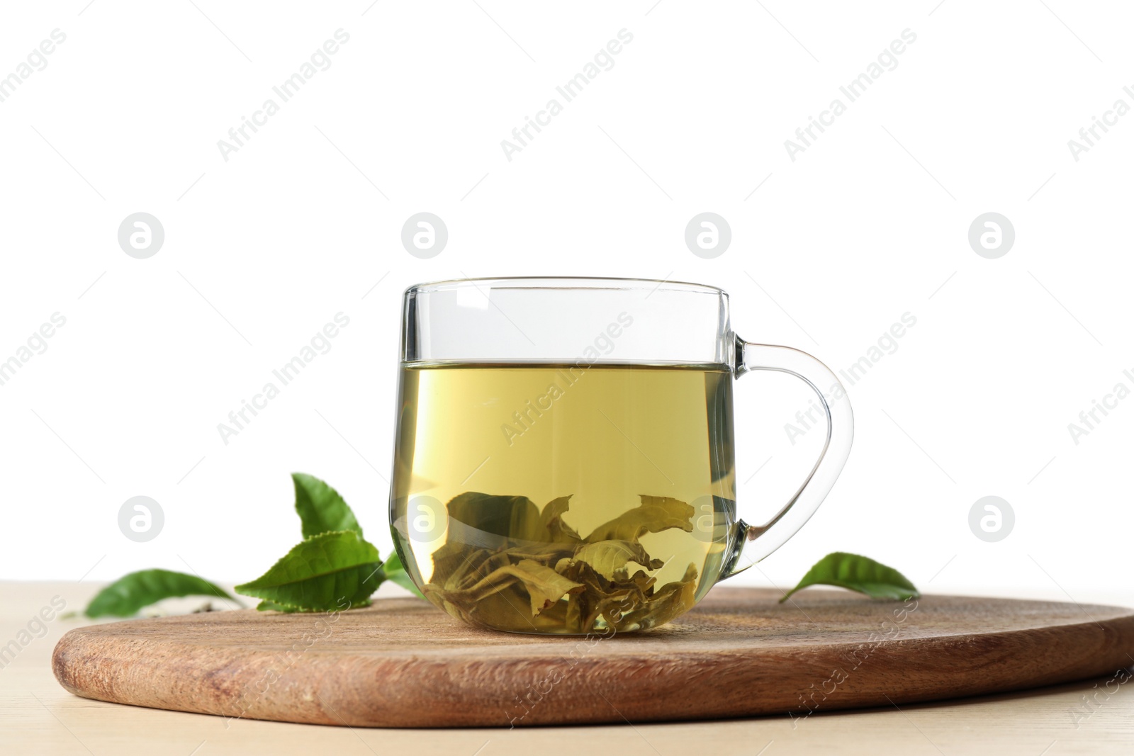 Photo of Tasty hot green tea on wooden table against white background