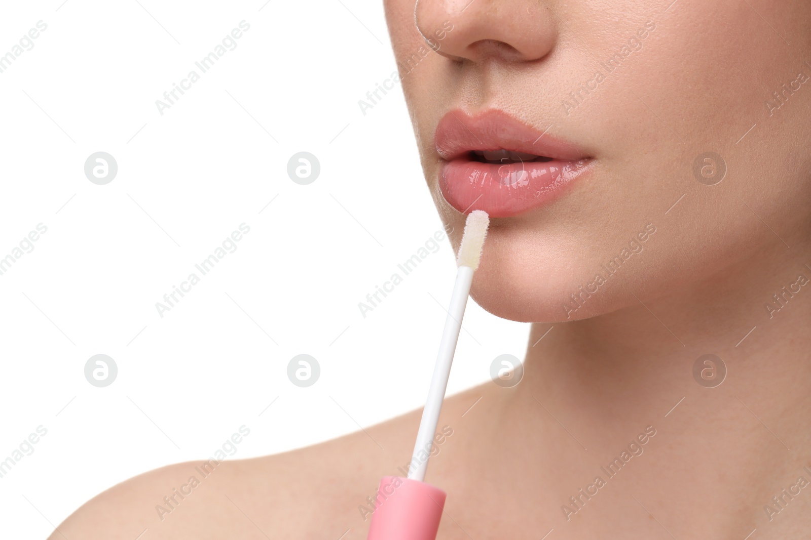 Photo of Woman applying lip gloss on white background, closeup