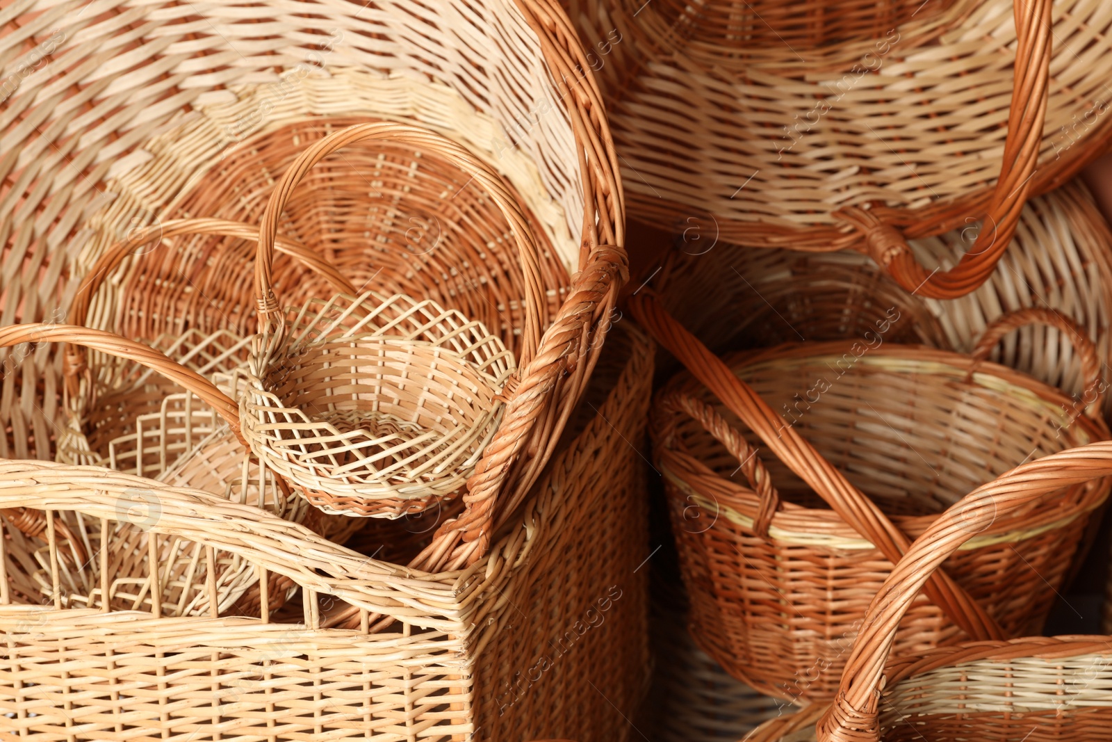 Photo of Many different wicker baskets made of natural material as background