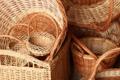 Many different wicker baskets made of natural material as background