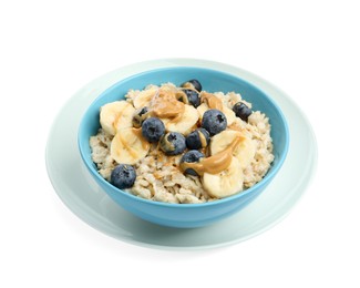 Tasty oatmeal with banana, blueberries and peanut butter in bowl isolated on white