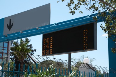 Photo of Direction sign and arrival board on city street