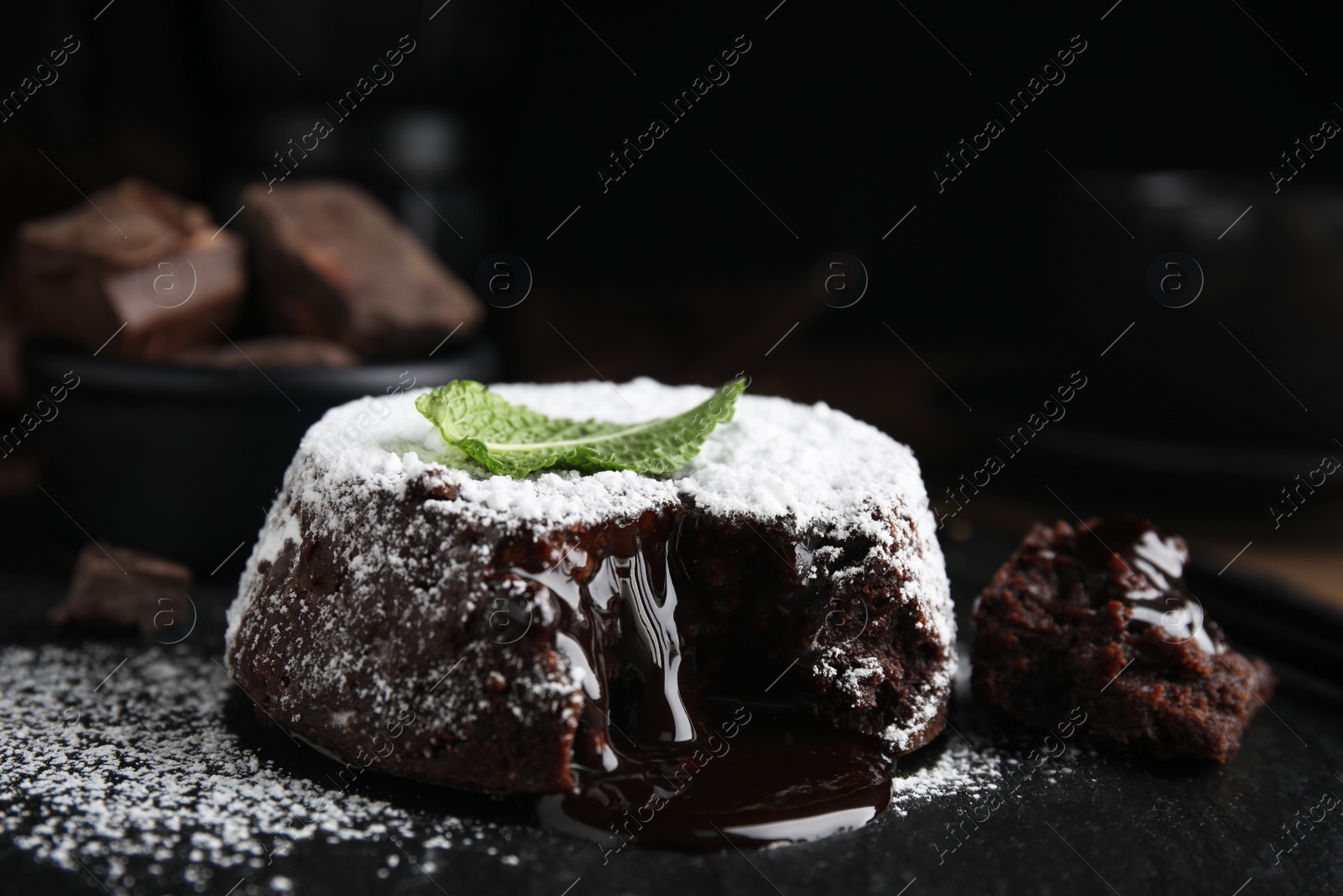 Photo of Delicious fresh fondant with hot chocolate and mint on slate plate, closeup