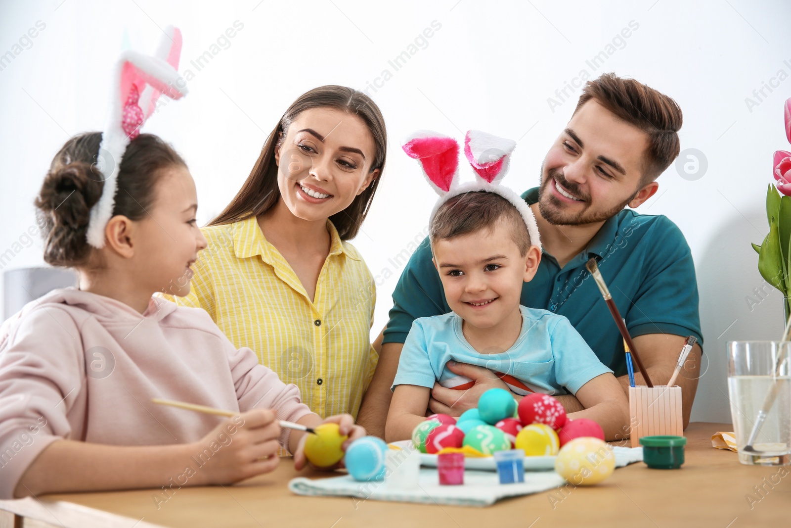 Photo of Happy family with Easter eggs at home. Festive tradition