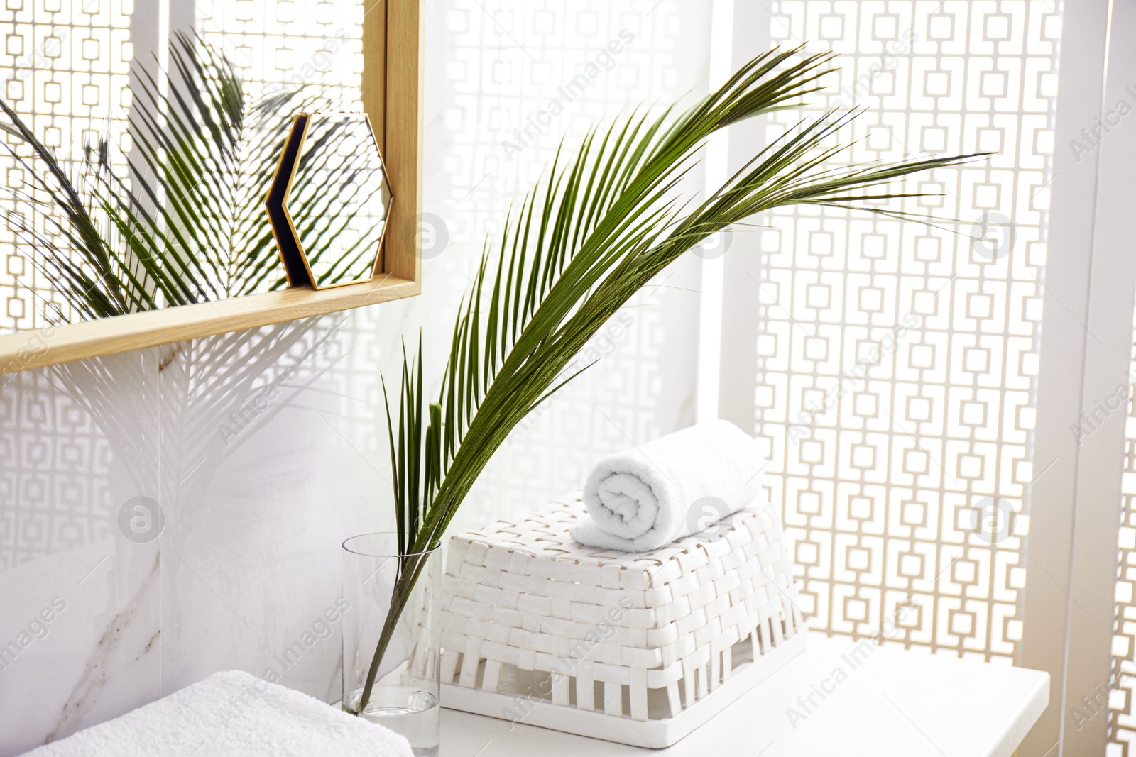 Photo of Tropical palm leaves in stylish bathroom interior