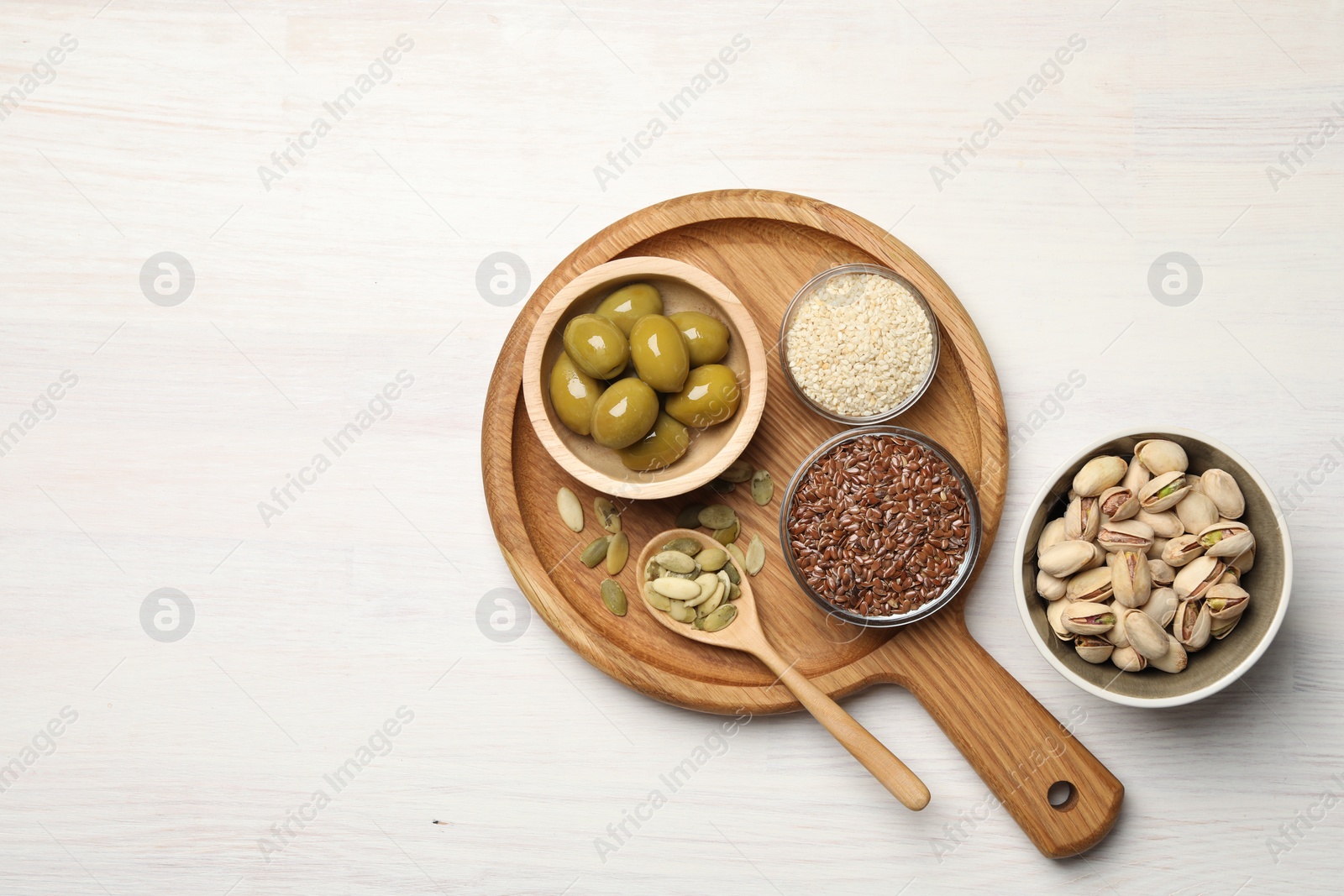 Photo of Different products high in vegetable fats on white wooden table, flat lay. Space for text