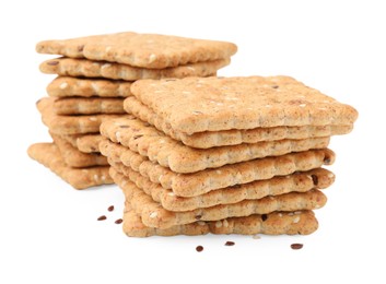 Photo of Stacks of cereal crackers with flax and sesame seeds isolated on white